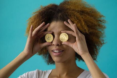 Bitcoin - Woman Holding Two Coins