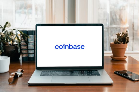 Coinbase - a laptop on a table