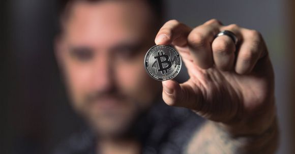 Bitcoin - Person Holding Silver Bitcoin Coin
