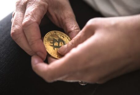 Ripple Coin - person holding round gold-colored Bitcoin