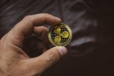 Ripple Coin - Person Holding Round Gold-colored Coin